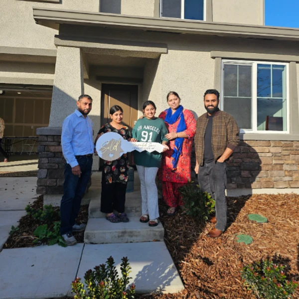New homeowners with keys — The Saini Realty